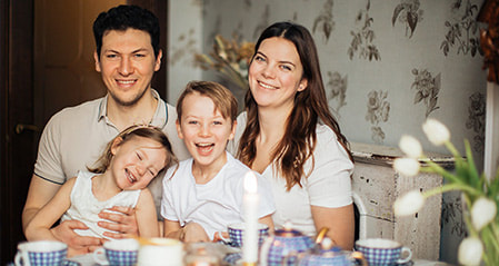Happy family in the dining with two children